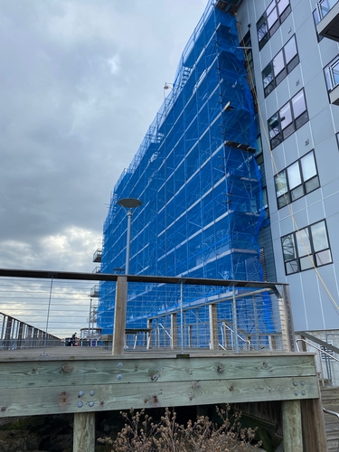 The buildings were wrapped in debris netting to protect pedestrians on the boardwalks below